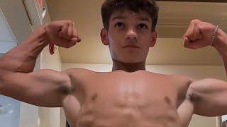 14 years old teen boy flexing muscle