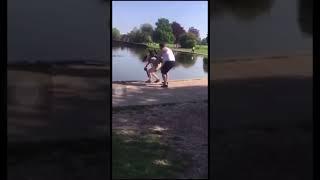 Guy pushes photographer into pond