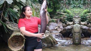 The girl lives in the middle of the green forest and makes bamboo cages to trap fish