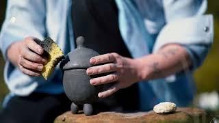 Making a teapot from clay in the nature...