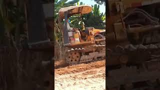 Khmer construction | Buldozer pushing soil    to build new road in Cambodia village