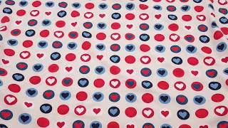 light beige knit fabric with colorful hearts by Stof Fabrics