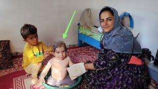 Bathing the young children of a single nomadic mother in the mountains