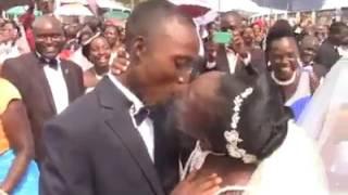 Kissing competition during mass wedding.