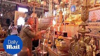 Thai king lights candles in Temple of the Emerald Buddha ceremony