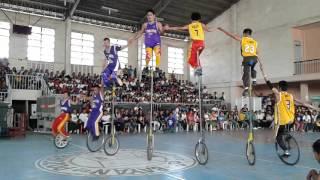 triple k acrobats playing basketball  using 3, 7 & 12 foot high unicycle