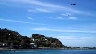 Helipro helicopters scoop water from Owhiro Bay whilst fighting scrub fire