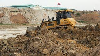 Powerful Stronger Construction Machinery Bulldozers Moving Dirt with Dump Trucks Unloading Dirt