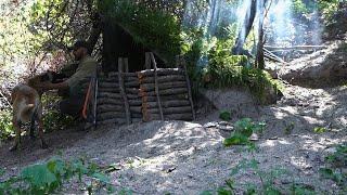 Bushcraft trip at my shelter. Shrubs for mosquitoes over the roof. Cooking at fireplace steak