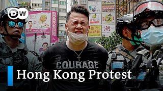 Hong Kong police enforce first arrests under new security law | DW News