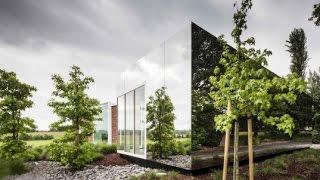 Gorgeous mirrored facade extension allows brick Belgian notary to blend into the landscape