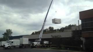 Workers continue they re roofing project at The News-Herald.