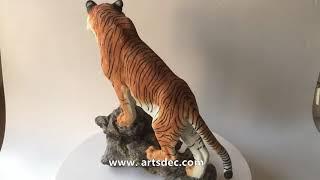 Resin craft tiger sculpture made of synthetic resin standing on a synthetic resin rockery