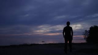 lonely man walking on a sunset beach