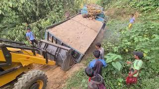 jcb backhoe loader helping a truck stuck in a hole