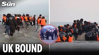 Moment migrants pack into dinghies for UK as French authorities look on