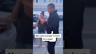 Man eats burger in front of vegan tiktok