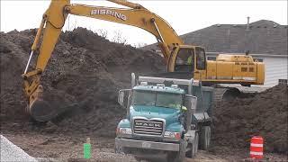 Discontinued Deere 450LC Large Excavator Loading Dump Trucks
