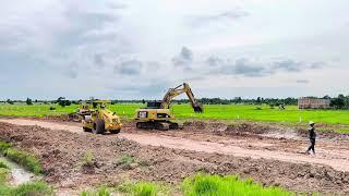 The machinery and activity indicate a large-scale earthmoving project,