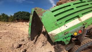 Dump truck unloading dirt