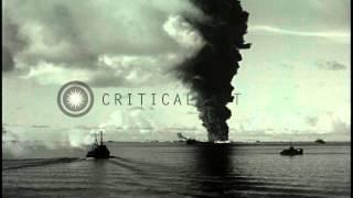 Huge smoke column rises from burning USS Mississinewa at Ulithi Lagoon at Pacific HD Stock Footage