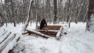 Building a Mini Shelter in a Snowy Ice Forest. Laying And Insulation Of Log Walls