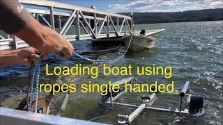 Loading boat using ropes single handed.