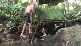 A cold Shelter Made Of THAL Branches  In The Forest On A Waterfall | BUSHCRAFT SURVIVE SHELTER.