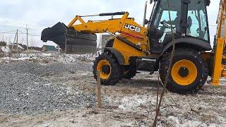 JCB Backhoe Collecting Gravel and Loading in Tractor. New tractor JCB 3CX - 2020