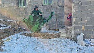 "Shadi Suzanne and her young children on a snowy day in their new rented house"