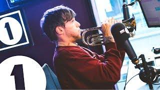 Louis Tomlinson plays trumpet and talks Tobey Maguire, Niall and Pelé