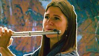 A talented young woman captivates the listeners at the subway station.