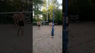 Beach volleyball, a sharp hit of the ball under the net.