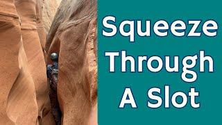 Squeezing Through A Slot Canyon With A Geologist