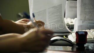 Hands And Pens On Clinic Reception. Stock Footage