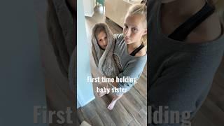 Elle gets to hold baby sister for the first time.  #sisters #funny #shortscreator