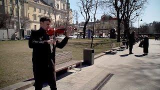 Street musician plays for Lviv residents as the city tries to keep up its spirit