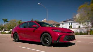 2025 Toyota Camry SE AWD in Supersonic Red Driving in the city