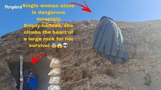Single woman alone on dangerous mountain She climbs a huge rock empty-handed for her survival