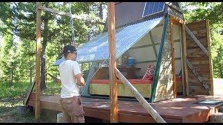 This affordable tiny house/cabin's entire wall swings open on pulleys!