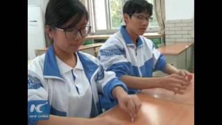 Chinese teenagers show pen tap skills