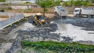 Expert Land Filling Procedure with Team Bulldozer Pushing Stone and Dump Truck Transporting Stone