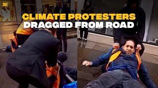 Members of public drag Just Stop Oil protesters from road