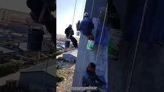 The process of priming the exterior of a building with ropes