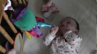 Rosa playing with captain calamari in cot