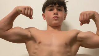 14 years old teen boy flexing muscle