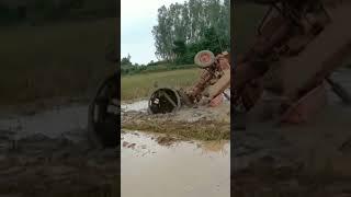 village tractor stucked in loose mud