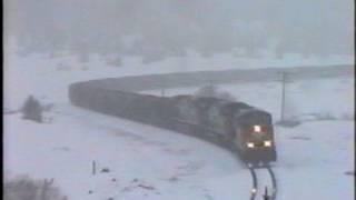 SP AC44's lead & mid-train & rear helpers battle 3.5% grade in the snow on Tennessee Pass...