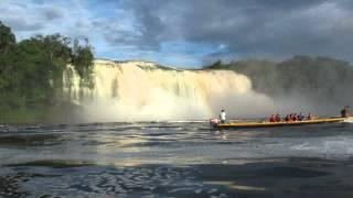 Hacha Falls with rainbow and indian dugout - Canaima National Park Venezuela