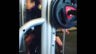 PT with a client 'squatting' with Smith machine